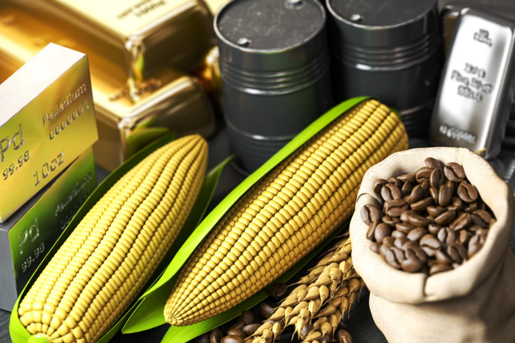 Soft Commodity Futures — corn, coffee beans, oil barrels, and gold bars representing global agricultural and industrial commodities.
