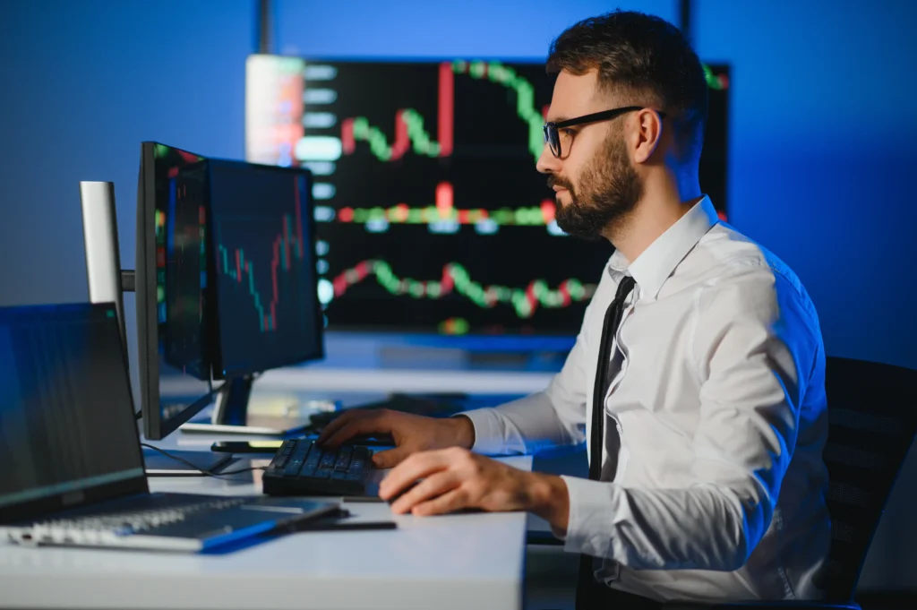 A forex trader analyzing live charts on multiple monitors while managing a Forex Trading Account in 2026.