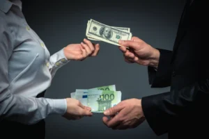 Business professionals exchanging US dollars and euros, illustrating Foreign Exchange Risk and currency value fluctuations.