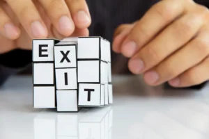 Time-Based Exits vs Price-Based Exits concept represented by a Rubik’s cube showing the word EXIT