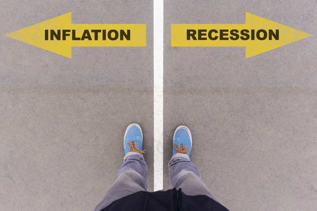 A person standing between arrows labelled inflation and recession, symbolising the Inflation and Recession impact on financial decisions.