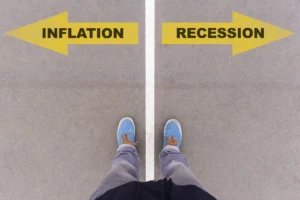 A person standing between arrows labelled inflation and recession, symbolising the Inflation and Recession impact on financial decisions.
