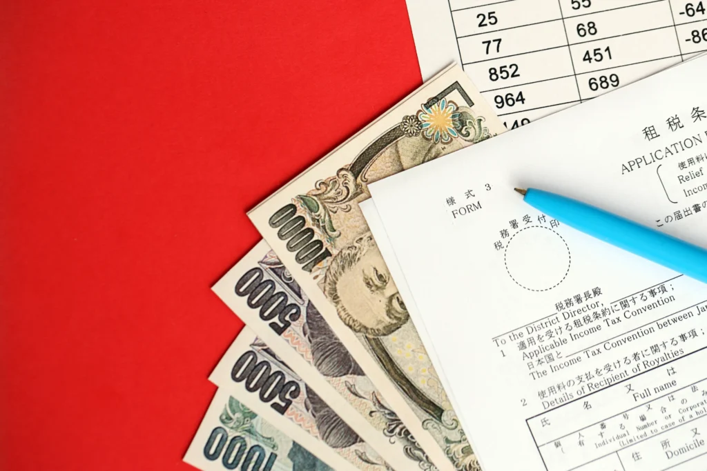 Japanese yen banknotes and financial documents symbolizing the Japan Bond Yield Rise and shifting market conditions.