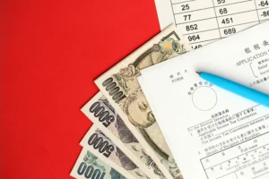 Japanese yen banknotes and financial documents symbolizing the Japan Bond Yield Rise and shifting market conditions.