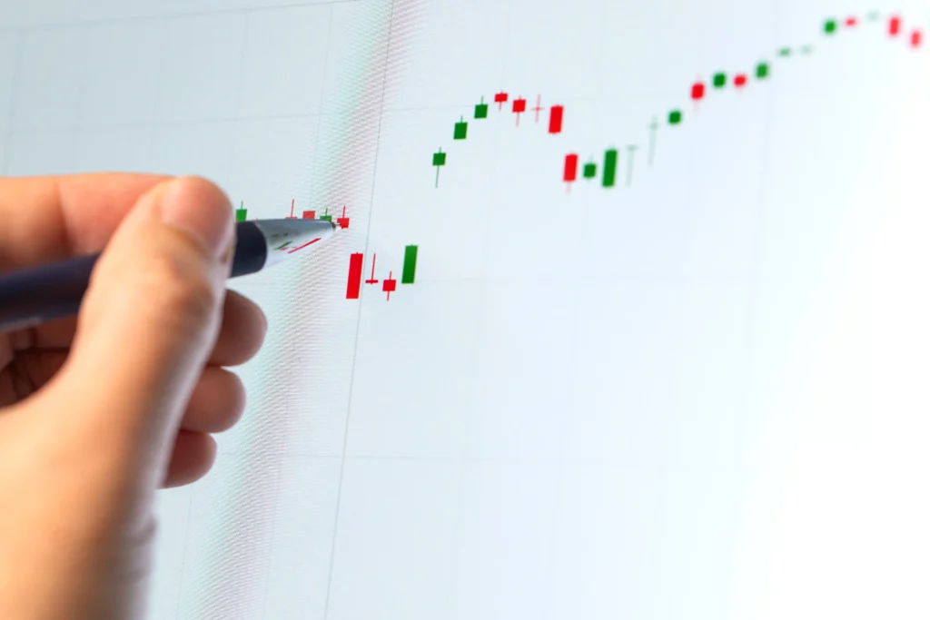 Trader analyzing candlestick chart pattern showing potential Hanging Man reversal signal.