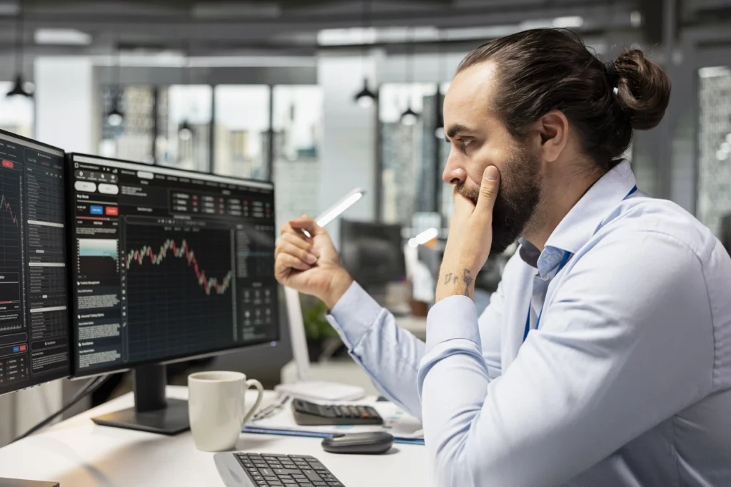 Trader analyzing forex charts and facing harsh trading realities.