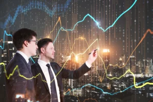 Two businessmen analyzing market charts and trend lines that illustrate concepts similar to Dow Theory.