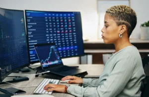 Trader applying position sizing techniques while analyzing charts for controlled risk management.