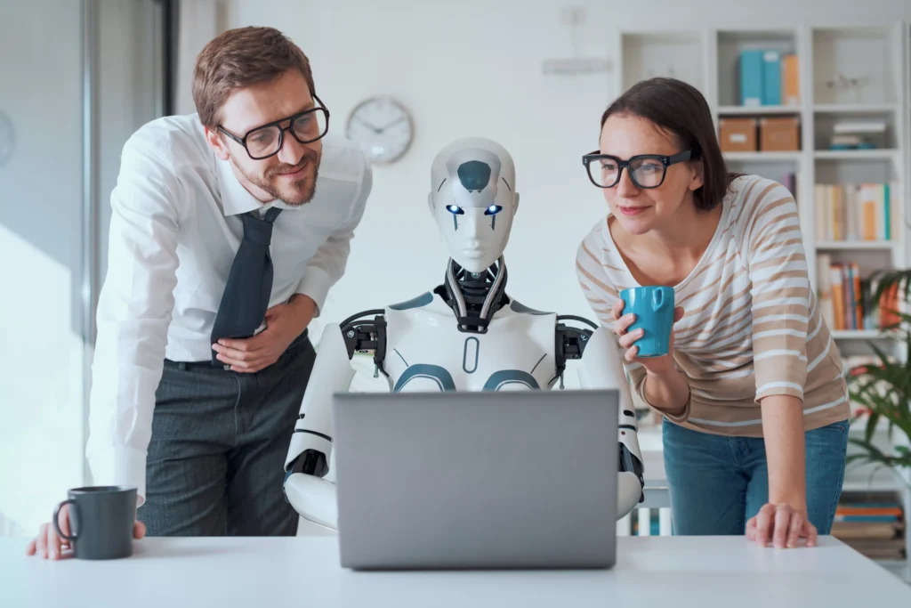 Automated Investing concept showing two professionals and a humanoid robot analyzing data on a laptop.