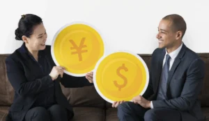 Two business professionals exchanging symbols of the Japanese yen and U.S. dollar, representing USD/JPY trading dynamics in 2026.
