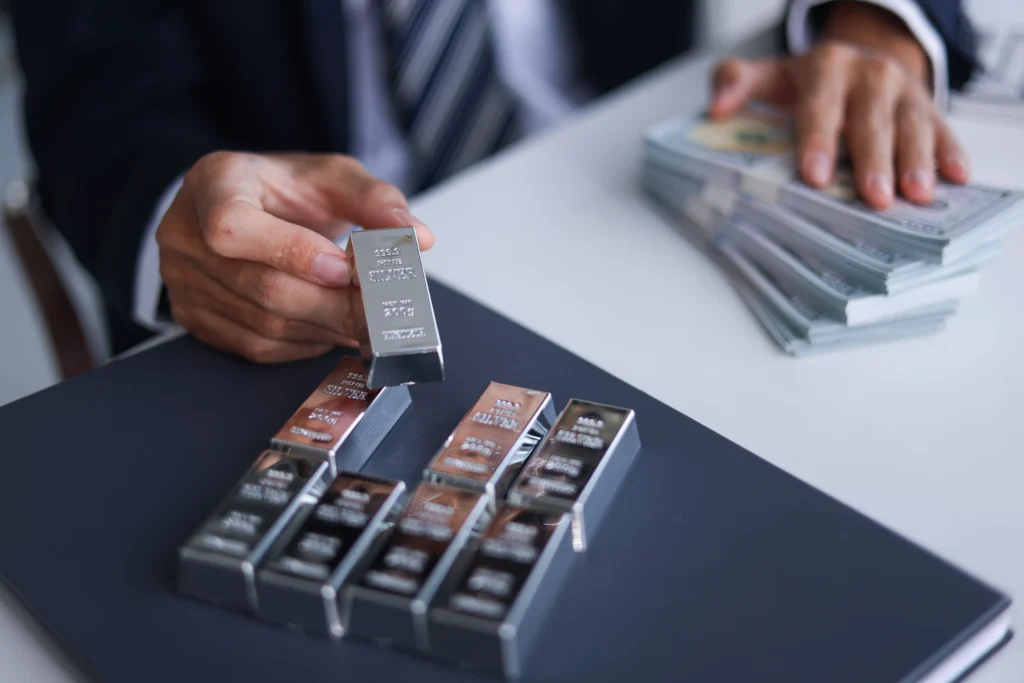 Businessman holding silver bars representing Silver ETFs investment in 2026 with currency notes symbolizing liquidity and financial growth.